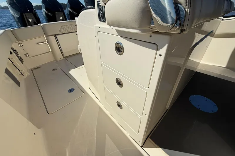 Slide: The Image of 2026 Scout 357 LXF boat interior with storage compartments and Mercury engines. - 34