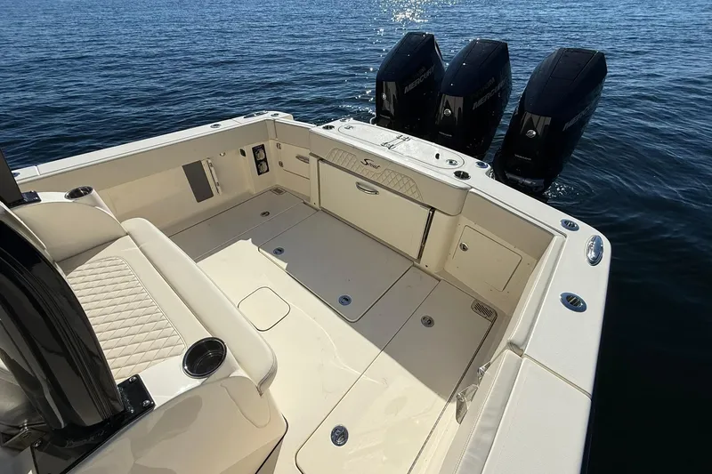 Slide: The Image of 2026 Scout 357 LXF boat with triple Mercury engines on calm water. - 36