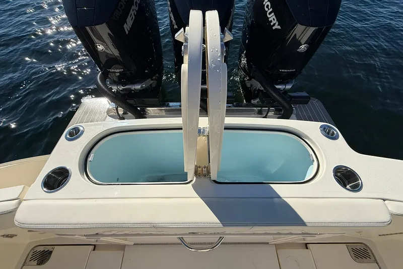 Slide: The Image of 2026 Scout 357 LXF boat with dual Mercury engines and livewell on water. - 39