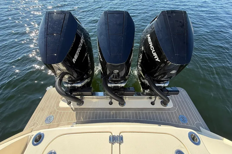 Slide: The Image of 2026 Scout 357 LXF boat with triple Mercury outboard engines on water. - 40