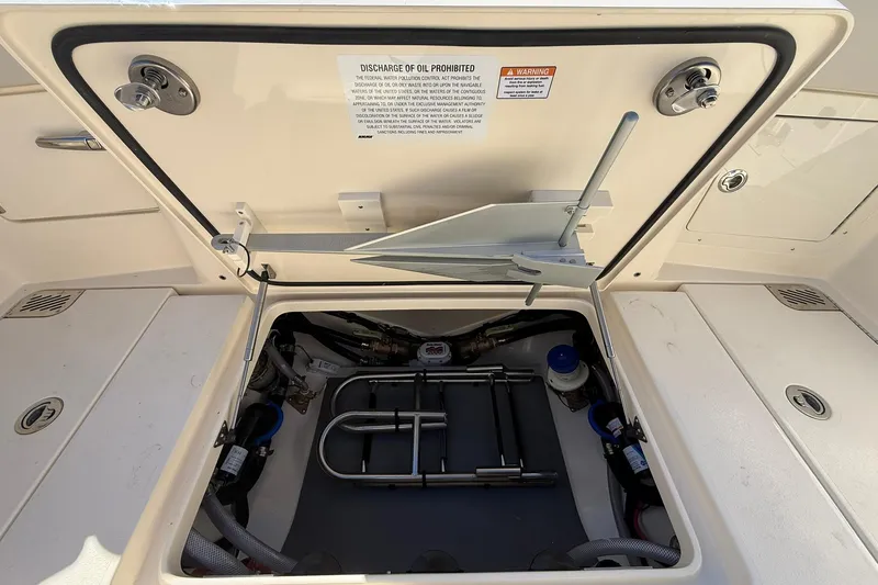Slide: The Image of Open hatch of 2026 Scout 357 LXF boat showing internal storage compartment. - 41
