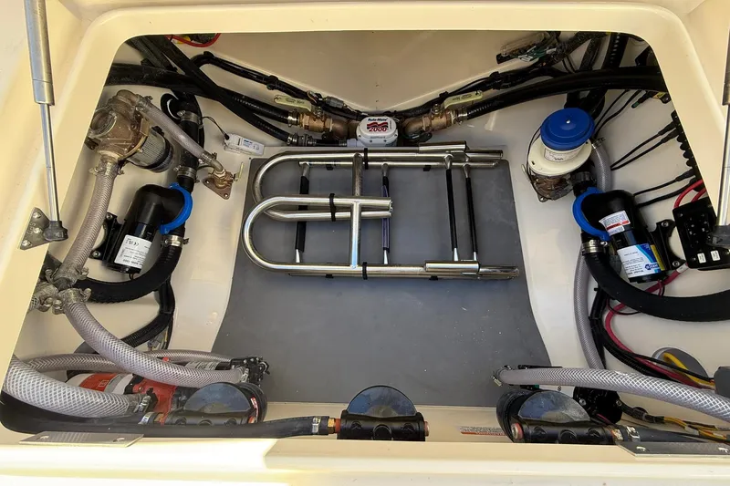 Slide: The Image of Engine compartment of 2026 Scout 357 LXF boat with visible wiring and components. - 42