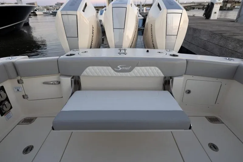 Slide: The Image of 2026 Scout 357 LXF boat interior with luxurious seating on a calm lake. - 7