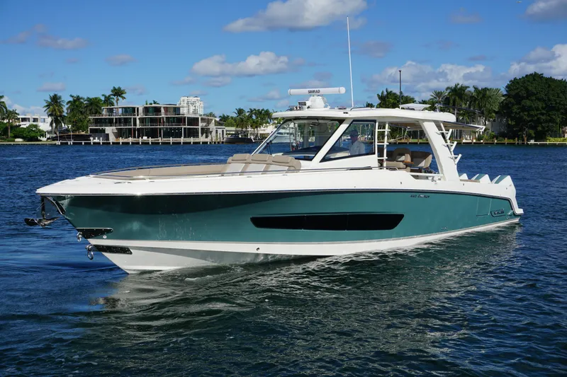 The Image of 2026 Boston Whaler 420 Outrage cruising on ocean near city skyline. - 0