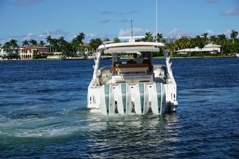 Slide: The Image of 2026 Boston Whaler 420 Outrage boat cruising on open water, clear sky background. - 11