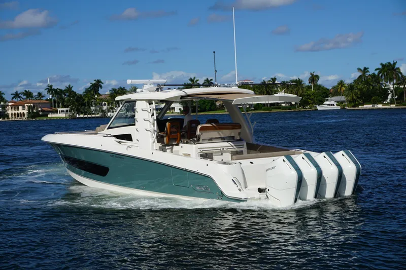 Slide: The Image of 2026 Boston Whaler 420 Outrage boat cruising on open ocean waters. - 12