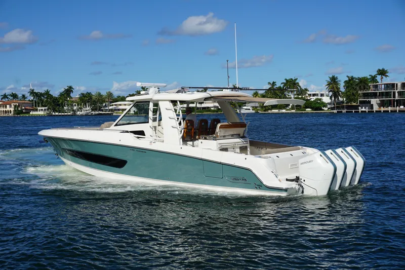 Slide: The Image of 2026 Boston Whaler 420 Outrage cruising on open ocean under blue sky. - 13