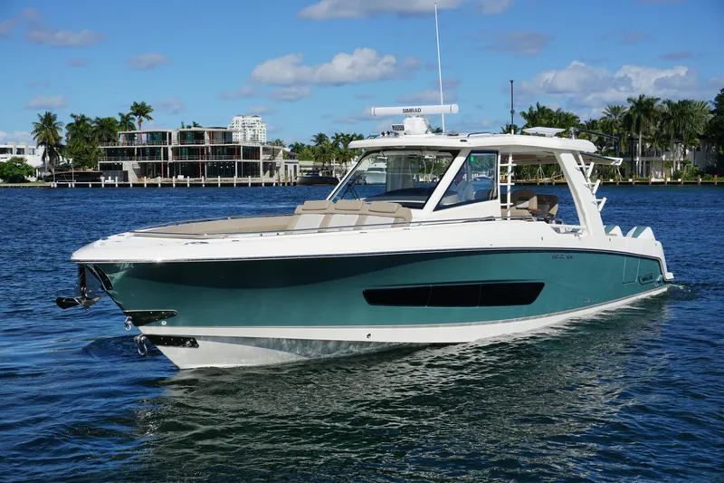 Slide: The Image of 2026 Boston Whaler 420 Outrage cruising on open water near city skyline. - 17
