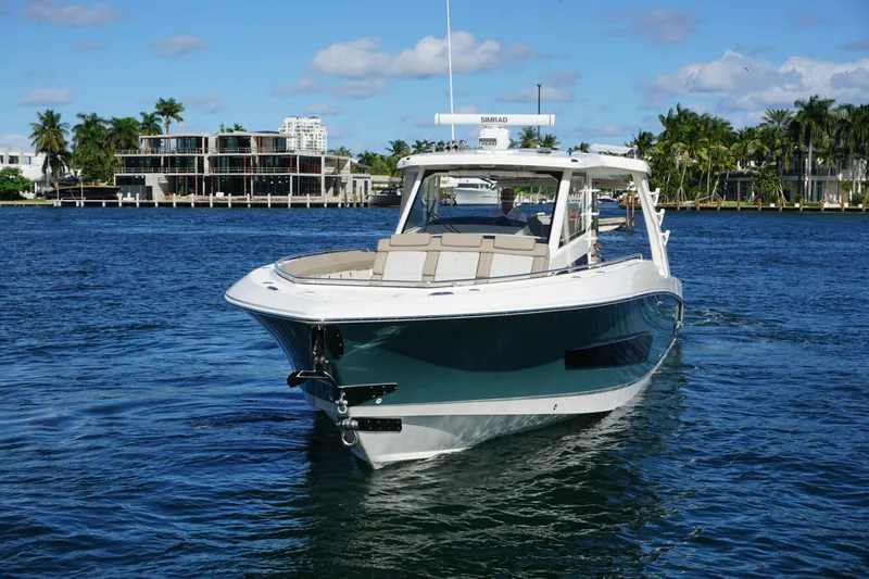Slide: The Image of 2026 Boston Whaler 420 Outrage cruising on sparkling blue ocean waters. - 19
