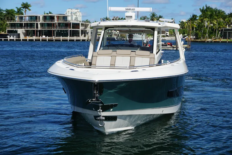 Slide: The Image of 2026 Boston Whaler 420 Outrage cruising on clear blue ocean waters. - 20
