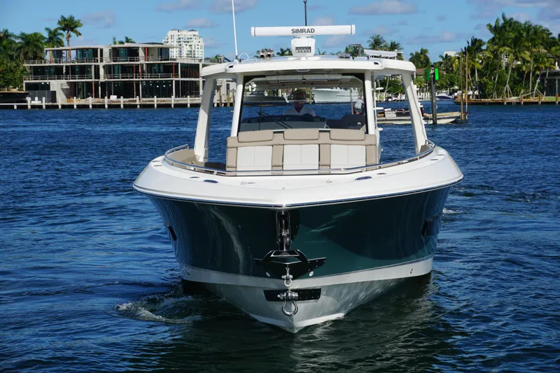 Slide: The Image of 2026 Boston Whaler 420 Outrage cruising on turquoise ocean waters. - 21