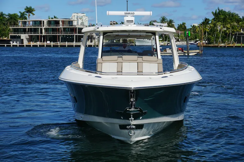 Slide: The Image of 2026 Boston Whaler 420 Outrage cruising on turquoise ocean under blue sky. - 22