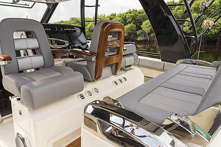 Slide: The Image of 2026 Boston Whaler 420 Outrage interior with modern seating, ambient lighting, and skylight. - 26
