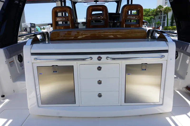 Slide: The Image of 2026 Boston Whaler 420 Outrage interior with modern design, ambient lighting, and entertainment system. - 28