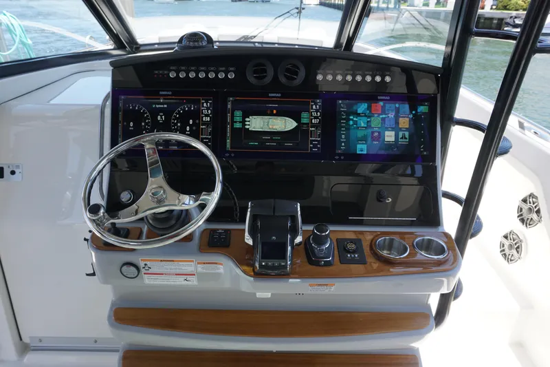 Slide: The Image of 2026 Boston Whaler 420 Outrage cruising on calm blue waters, showcasing luxury seating. - 29