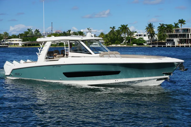 Slide: The Image of 2026 Boston Whaler 420 Outrage boat on ocean with city skyline background. - 3