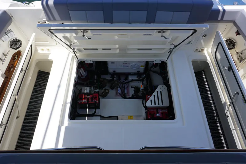 Slide: The Image of 2026 Boston Whaler 420 Outrage boat docked in sunny marina with cityscape background. - 31