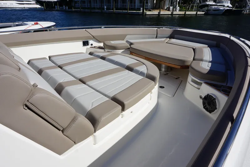 Slide: The Image of 2026 Boston Whaler 420 Outrage boat interior with seating and table on calm water. - 32