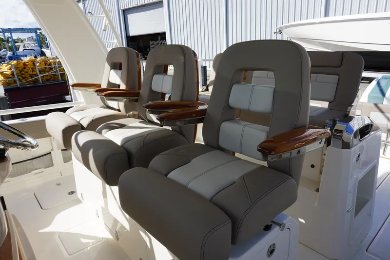Slide: The Image of 2026 Boston Whaler 420 Outrage boat interior with luxurious seating and cup holders. - 35