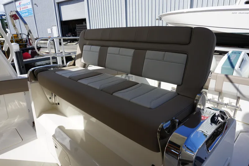 Slide: The Image of 2026 Boston Whaler 420 Outrage in marina, sunny day, city skyline in background. - 36