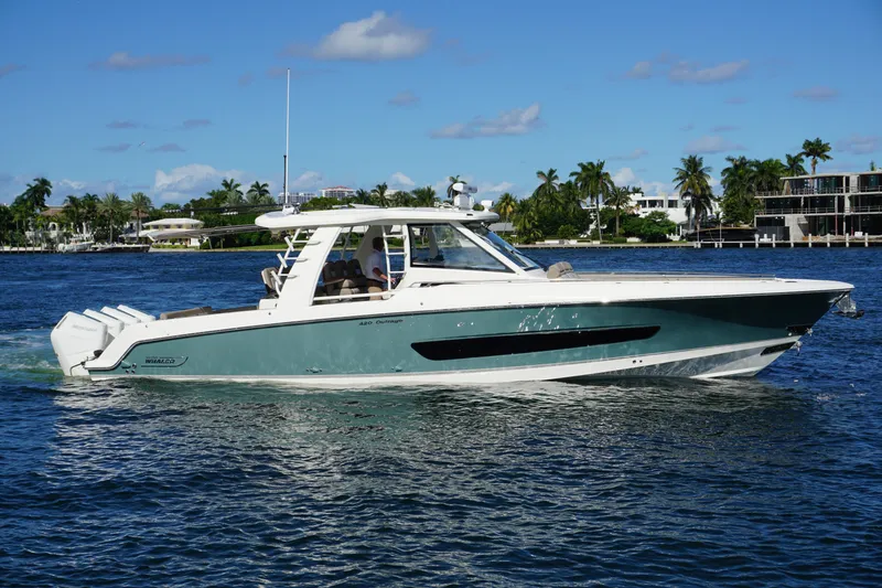 Slide: The Image of 2026 Boston Whaler 420 Outrage cruising on blue ocean near city skyline. - 4