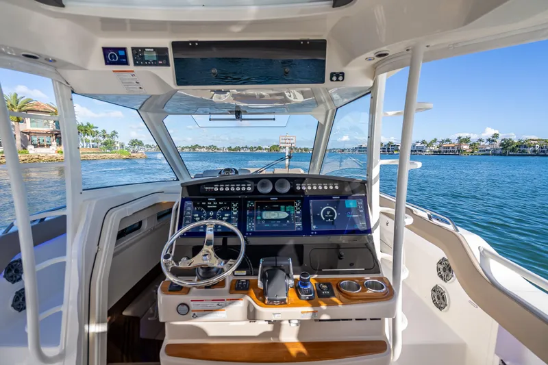 Slide: The Image of 2026 Boston Whaler 420 Outrage helm with advanced navigation system on open water. - 41