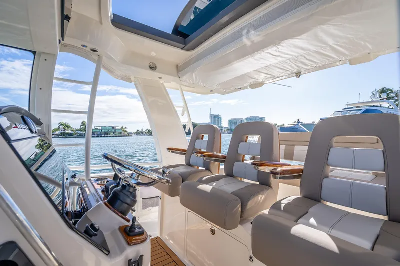 Slide: The Image of Interior of 2026 Boston Whaler 420 Outrage, featuring luxurious seating and modern helm. - 45