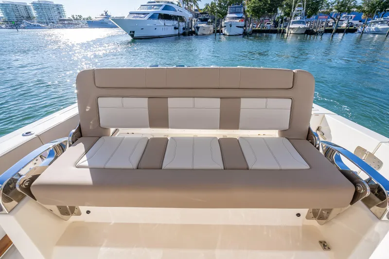 Slide: The Image of 2026 Boston Whaler 420 Outrage boat seating with marina view. - 46