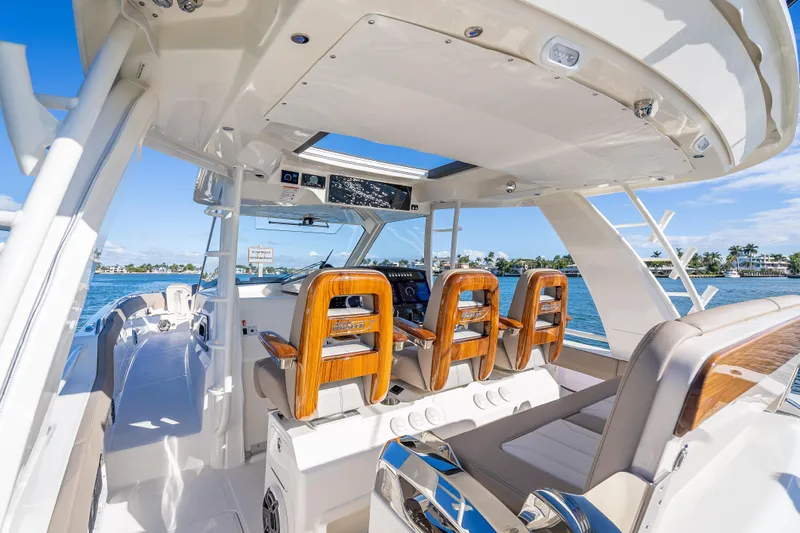 Slide: The Image of 2026 Boston Whaler 420 Outrage boat interior with luxurious seating and ocean view. - 48