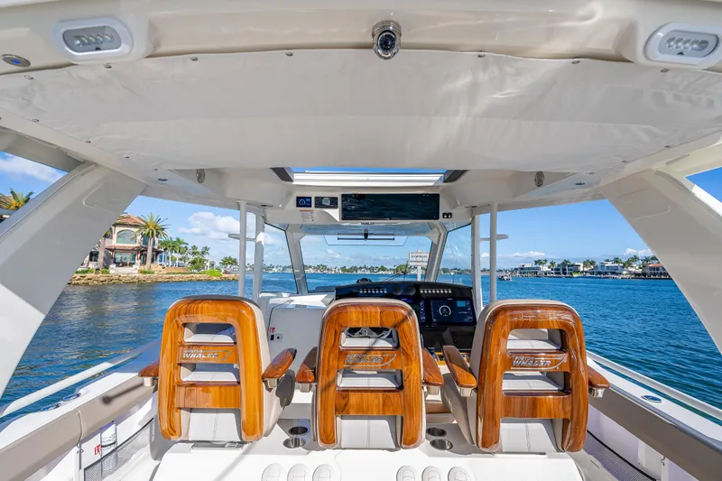 Slide: The Image of 2026 Boston Whaler 420 Outrage helm with luxurious seating and waterfront view. - 49