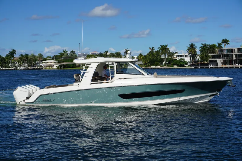 Slide: The Image of 2026 Boston Whaler 420 Outrage cruising on ocean near city skyline. - 5