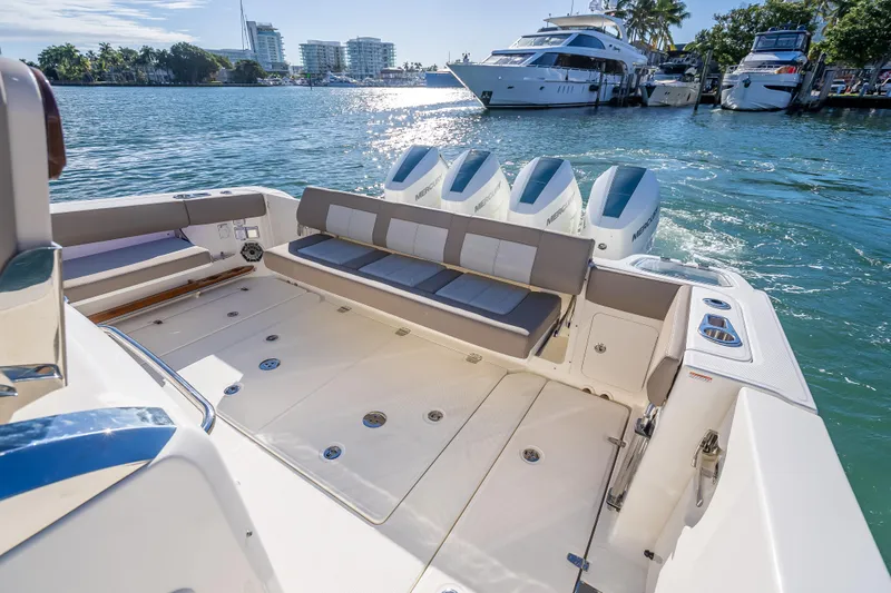Slide: The Image of 2026 Boston Whaler 420 Outrage boat with spacious deck and powerful engines docked in marina. - 50