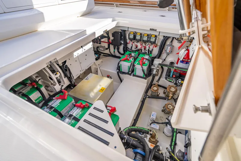 Slide: The Image of 2026 Boston Whaler 420 Outrage engine compartment with batteries and wiring. - 53