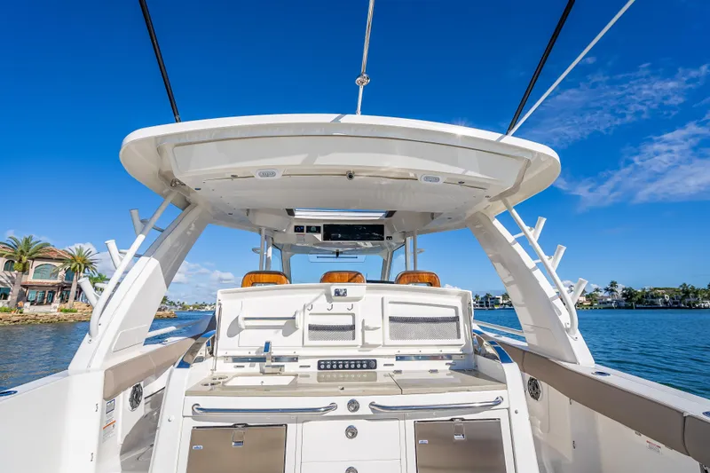 Slide: The Image of 2026 Boston Whaler 420 Outrage boat interior with clear blue sky and waterfront view. - 58