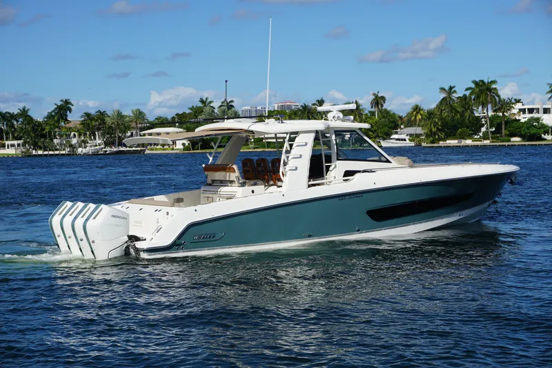 Slide: The Image of 2026 Boston Whaler 420 Outrage cruising on open ocean near city skyline. - 6