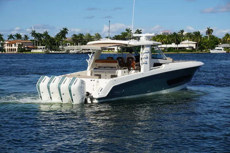 Slide: The Image of 2026 Boston Whaler 420 Outrage cruising on open water, showcasing luxury and performance. - 7