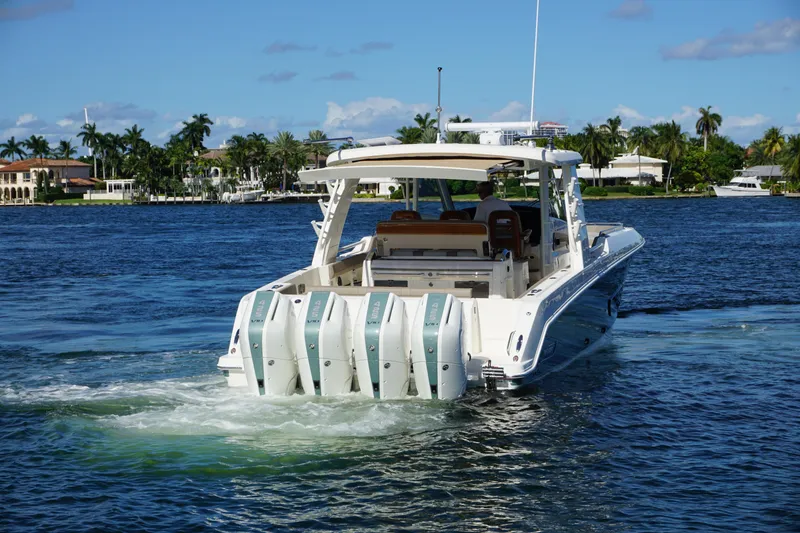 Slide: The Image of 2026 Boston Whaler 420 Outrage cruising on open water, showcasing sleek design and powerful engines. - 8