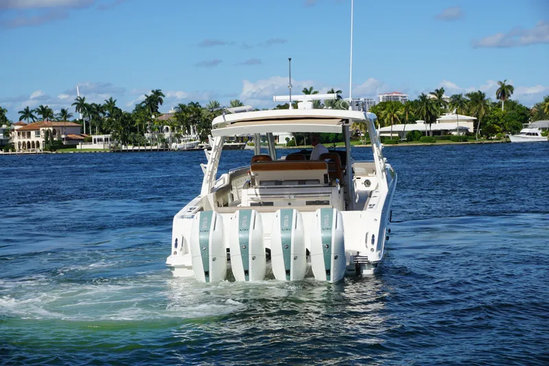 Slide: The Image of 2026 Boston Whaler 420 Outrage on open sea with four powerful outboard engines. - 9