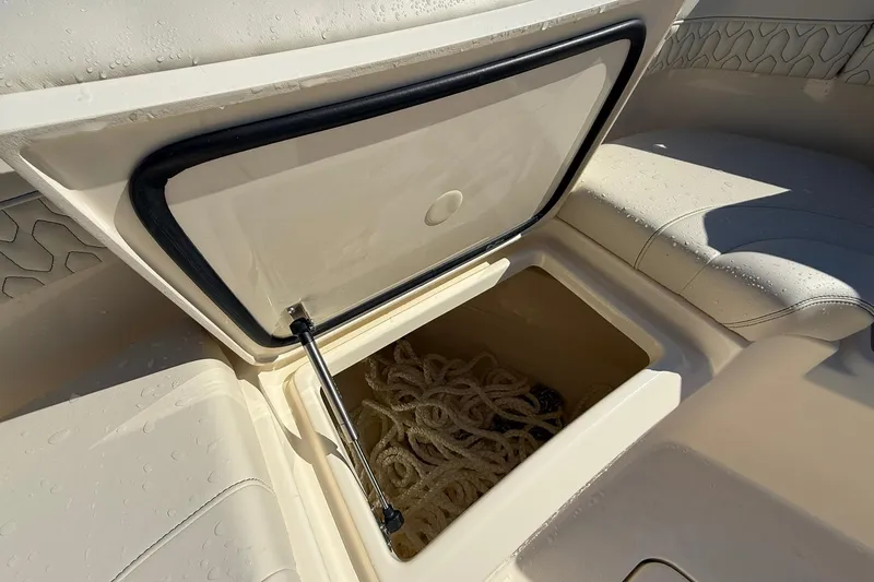 Slide: The Image of Open storage compartment on 2026 Scout 288 LXF boat with rope inside. - 11