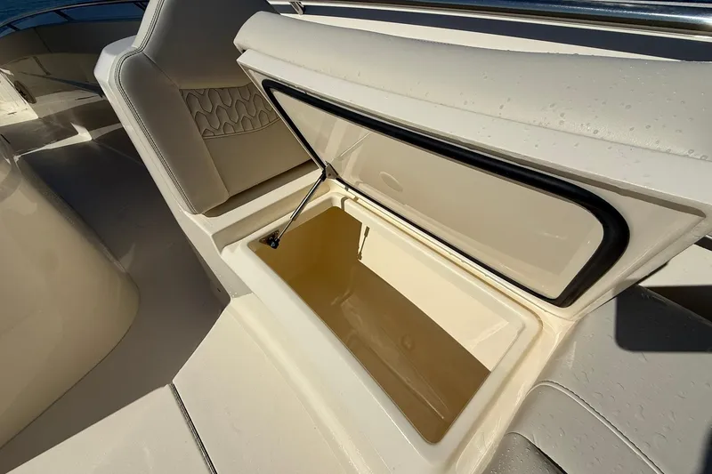 Slide: The Image of Open storage compartment on 2026 Scout 288 LXF boat, showcasing interior design. - 12