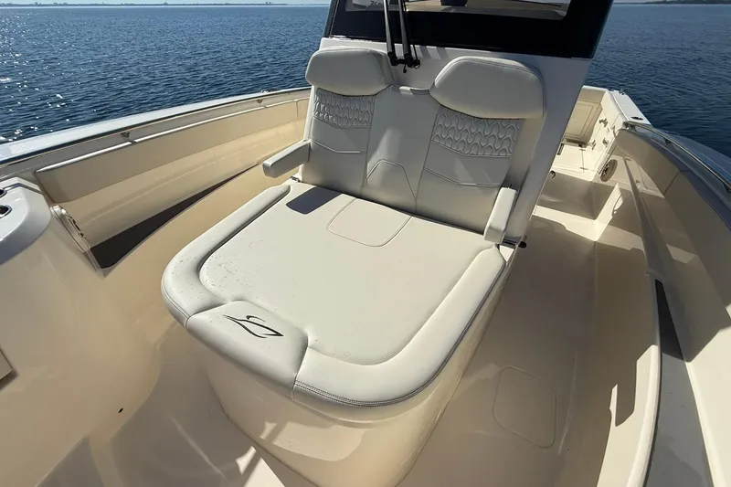 Slide: The Image of 2026 Scout 288 LXF boat with luxurious seating on calm water. - 15