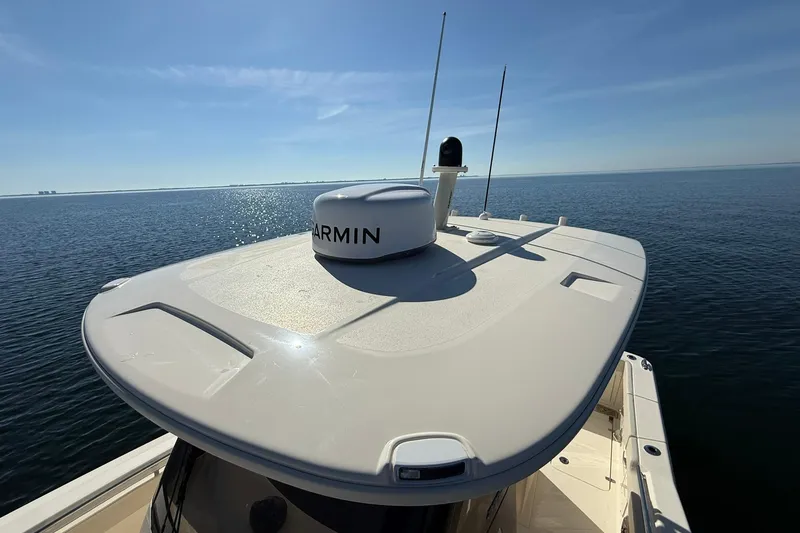 Slide: The Image of 2026 Scout 288 LXF boat with Garmin equipment on open water. - 17