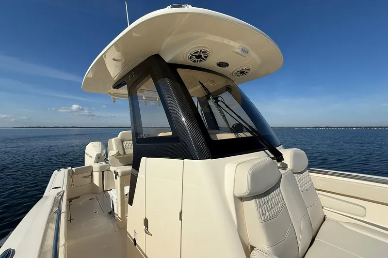 Slide: The Image of 2026 Scout 288 LXF boat on calm water, featuring sleek design and modern amenities. - 19