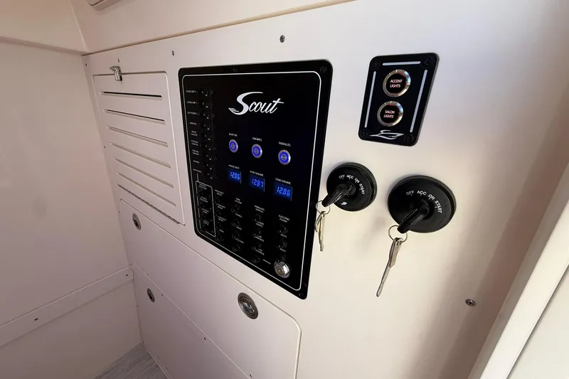 Slide: The Image of Control panel of 2026 Scout 288 LXF boat with keys and light switches. - 25