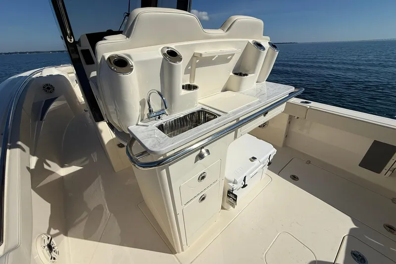 Slide: The Image of 2026 Scout 288 LXF boat interior with sink and storage, ocean view. - 31