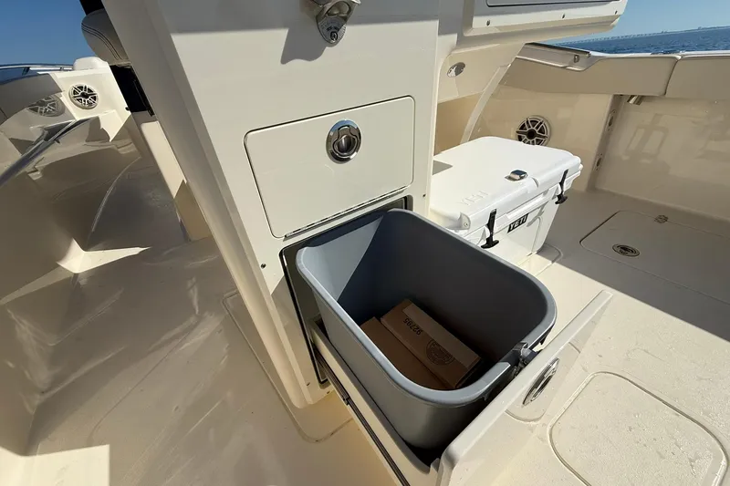 Slide: The Image of 2026 Scout 288 LXF boat interior with storage compartment and YETI cooler. - 36