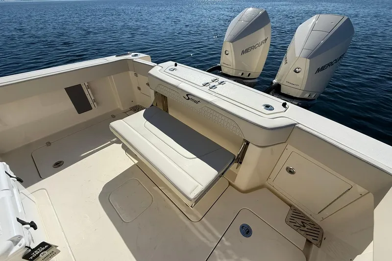 Slide: The Image of 2026 Scout 288 LXF boat with dual Mercury engines on calm water. - 39