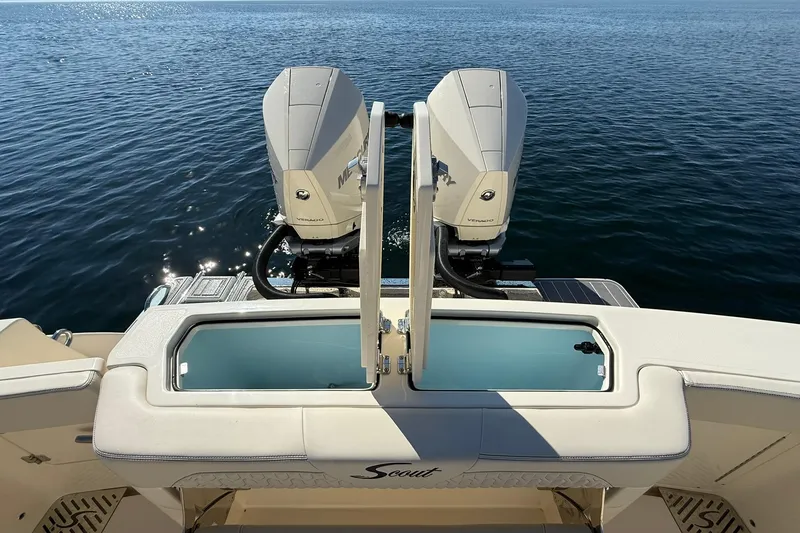 Slide: The Image of 2026 Scout 288 LXF boat with dual Mercury engines on calm water. - 40