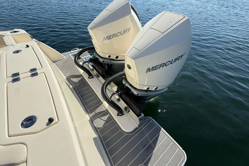 Slide: The Image of 2026 Scout 288 LXF boat with dual Mercury outboard engines on water. - 45