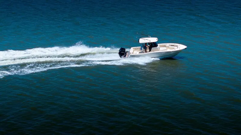 Slide: The Image of 2026 Scout 288 LXF boat cruising on a serene lake. - 5